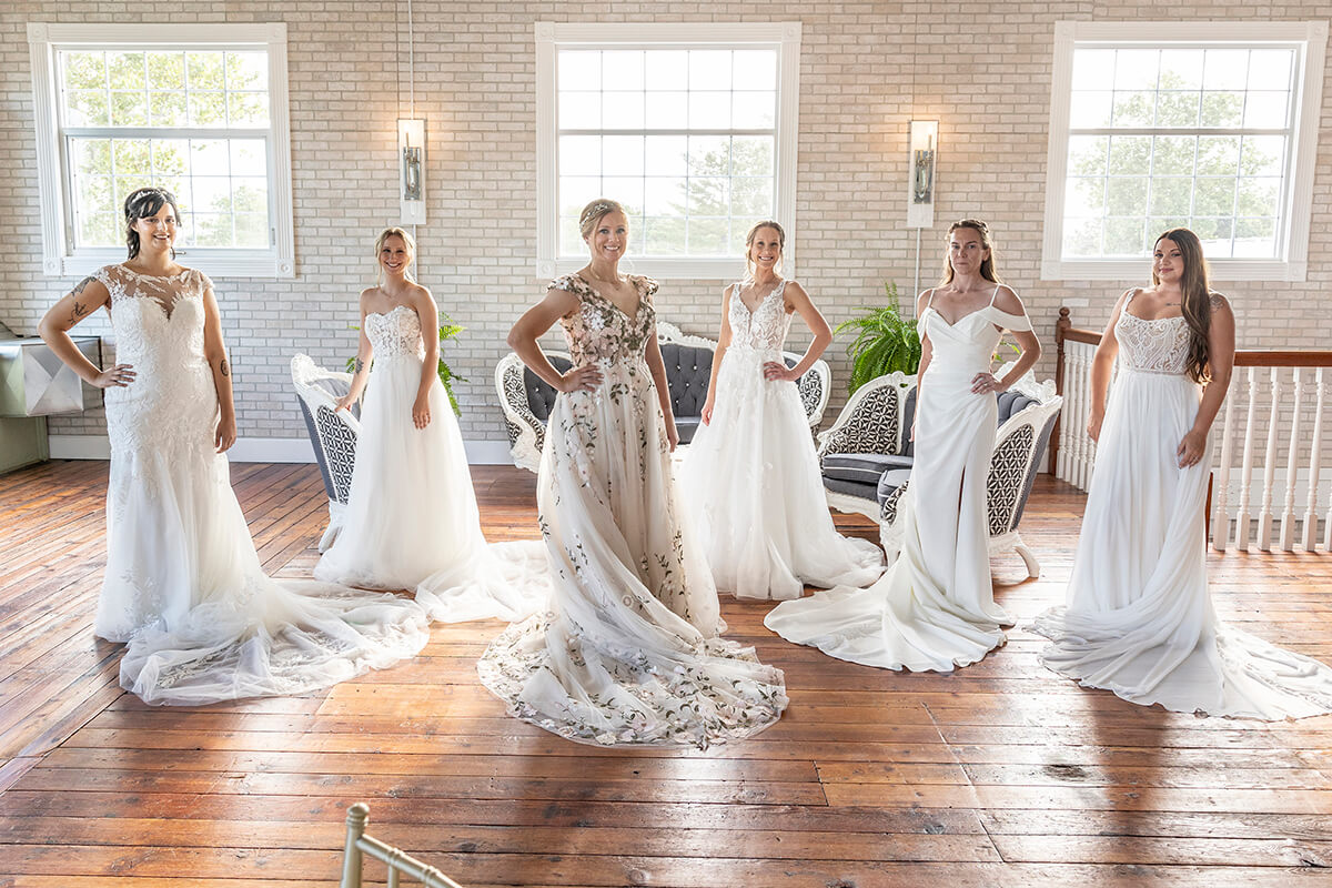 A group of women standing together, elegantly dressed in wedding gowns, showcasing beauty and celebration for special occasions